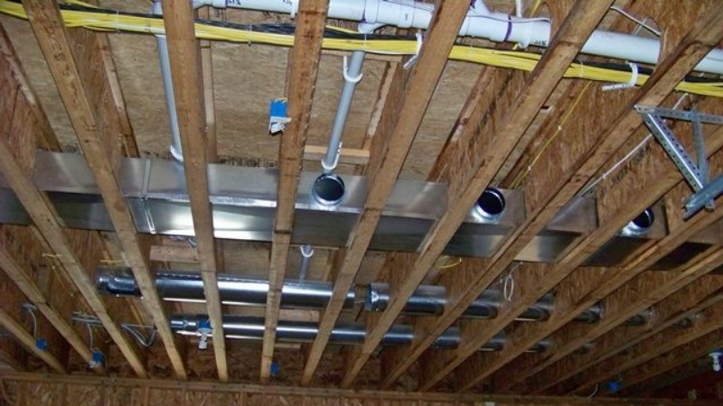 Running pipes and wires in a wooden floor saves space