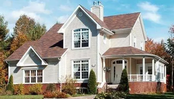  This home perfectly suited for a corner lot. House facade has horizontal siding, an arched entry door with a transom window above, front porch arches. A complex roof with large front-facing gables…