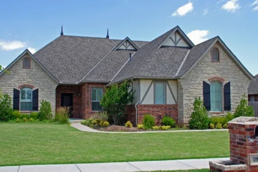  This French countryside house facade has mixed materials, decorative trim, carved brackets, arched windows and doors with keystones, bay window and faced with horizontal siding, stone. A complex roof…