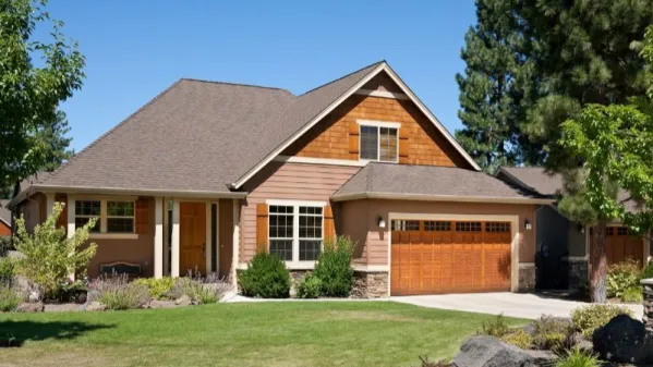  This house facade has decorative trim, shuttered windows and faced with horizontal siding, stone and wood shakes. A complex roof with large front facing gables completes the look of this house. House…