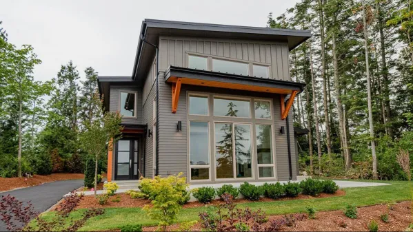 On the main floor, the open living area of the combined kitchen, dining room and living room - open to above - gives a spacious feeling. The kitchen island has two sinks, a dishwasher, prep space and…